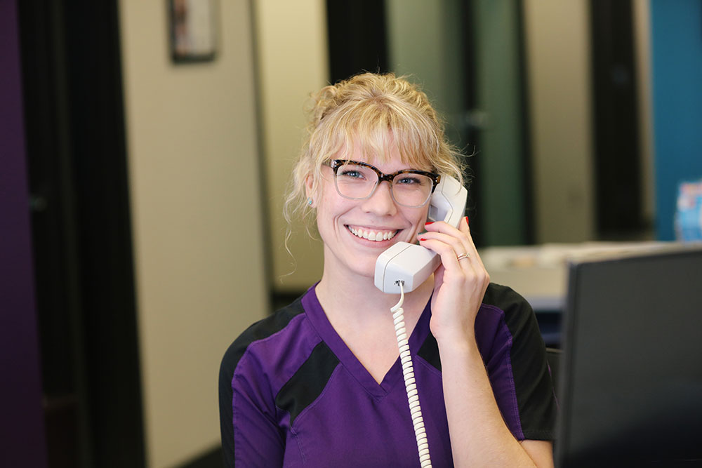 smiling receptionist on phone