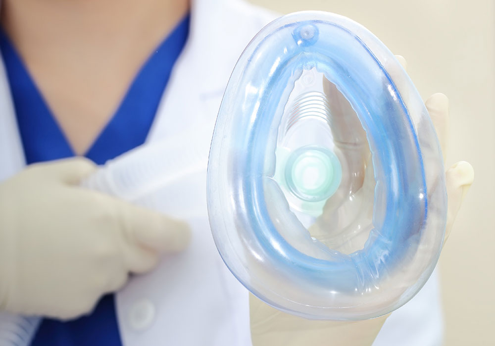 technician holding a nitrous mask