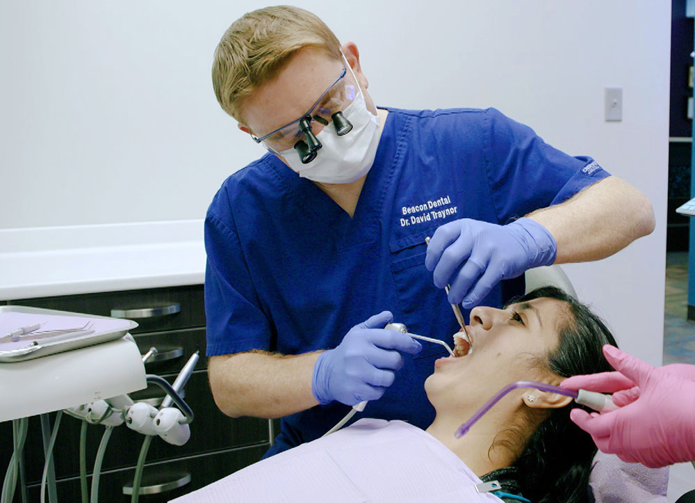 Dr. Traynor with instruments in patient's mouth