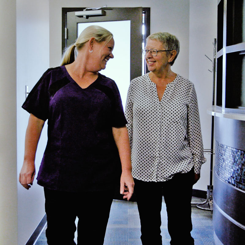 dental assistant walking down the hall with a patient